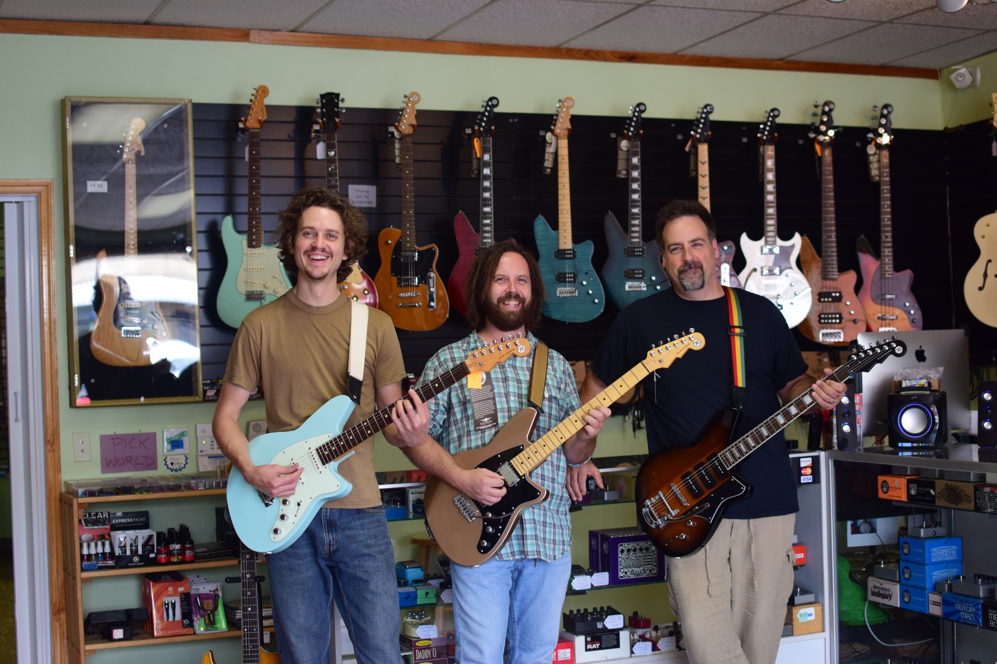Musicians with guitars inside the shop