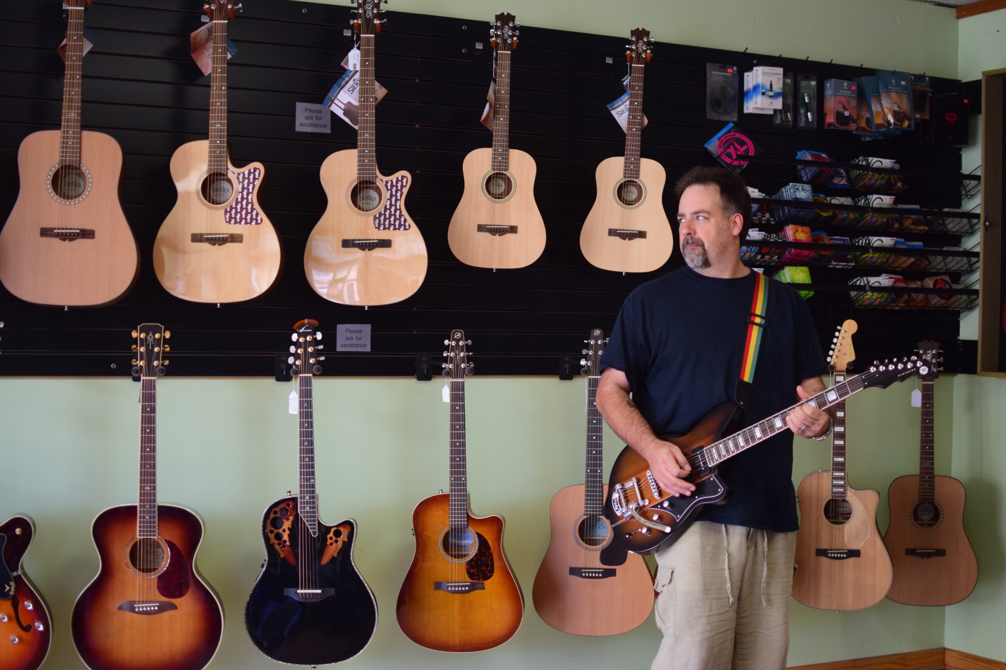 Playing an electric guitar inside The Guitar Trader